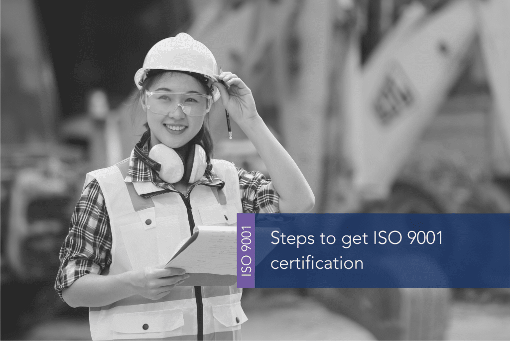 A person wearing a hard hat and safety vest