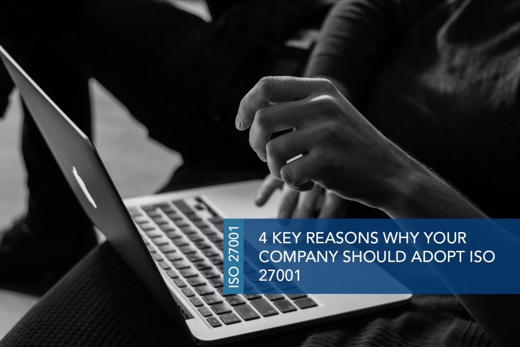 Black and white image of hands typing on a laptop keyboard