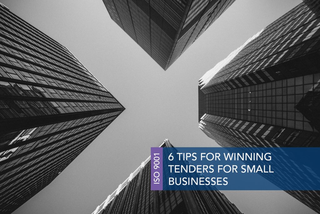 Black and white image of a view of tall buildings that look like skyscrapers from the ground